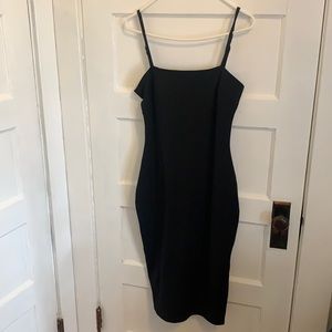 Black, form-fitting, cocktail dress